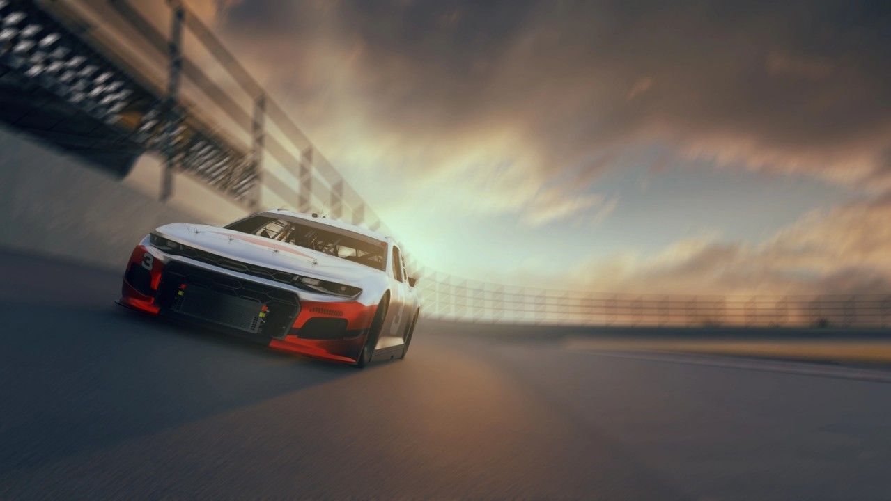 Race car speeding around a track, against a cloudy sky. White and red vehicle on a banked curve.