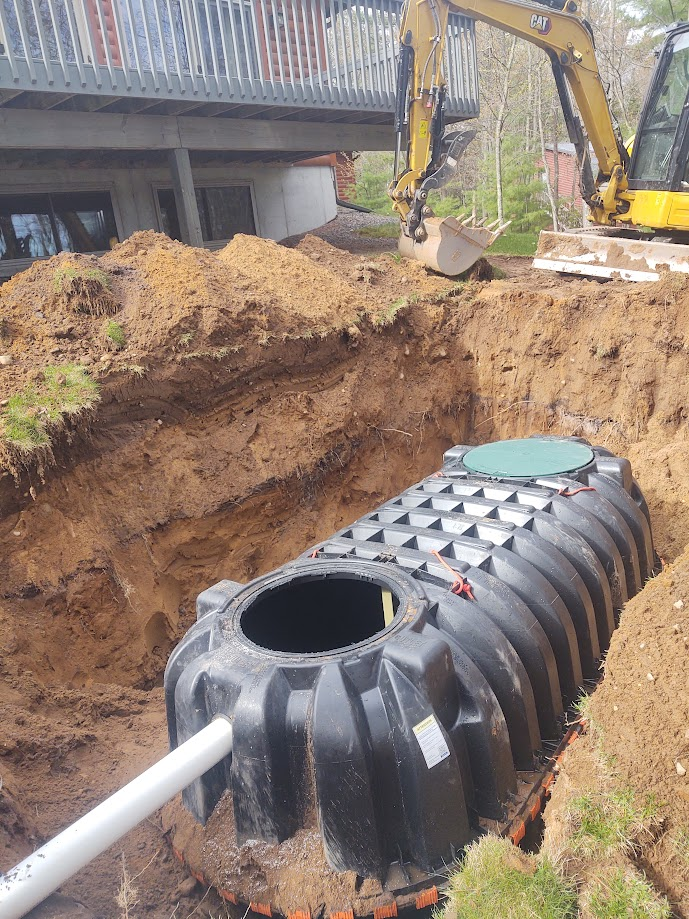 A septic tank is being installed in a hole in the ground.