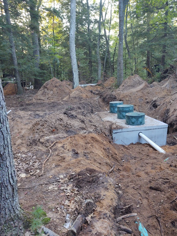 A septic tank is being built in the middle of a forest.