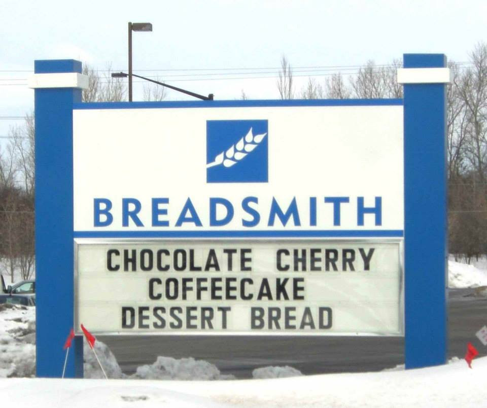 A sign that says breadsmith chocolate cherry coffeecake dessert bread