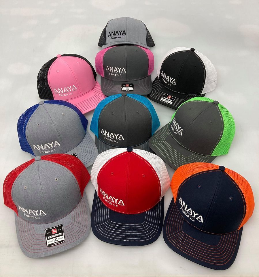 A bunch of hats are sitting on top of each other on a table.