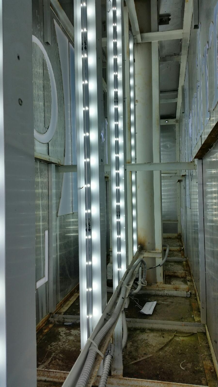 A row of lights hanging from the ceiling of a building.