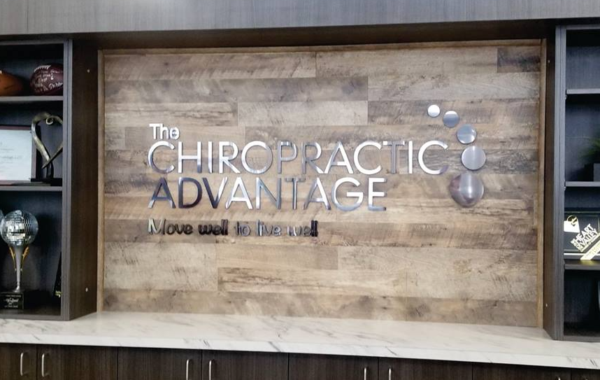 A wooden wall with the words `` the chiropractic advantage '' written on it.