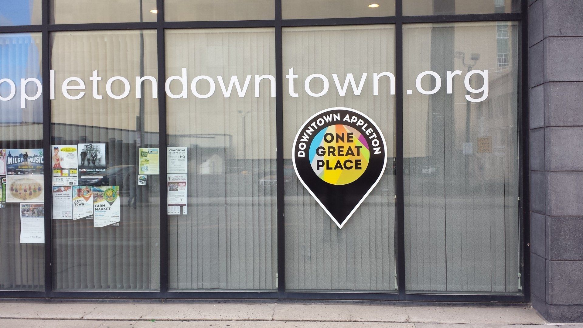 A window with a one great place logo on it