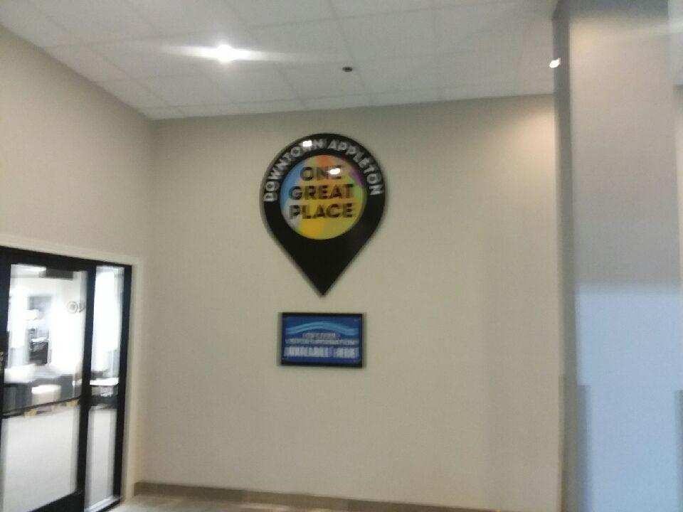 A sign on a wall that says great place