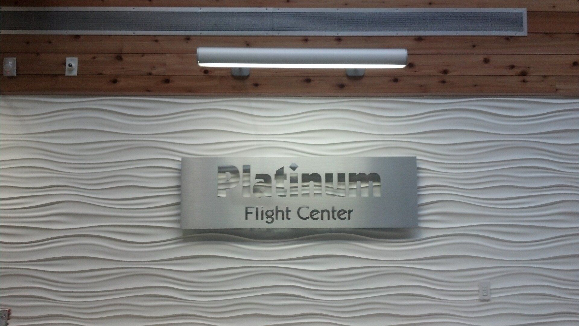 A sign on a wall that says platinum flight center