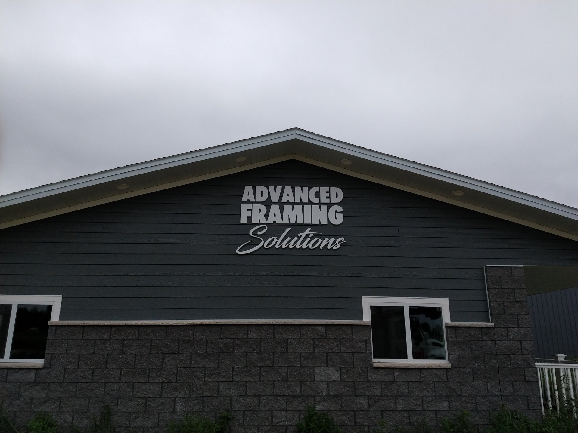 A building with a sign on it that says advanced framing solutions