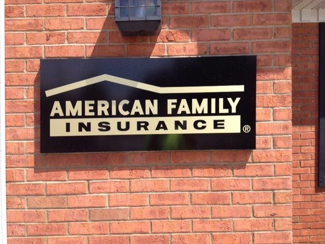 An american family insurance sign on a brick wall