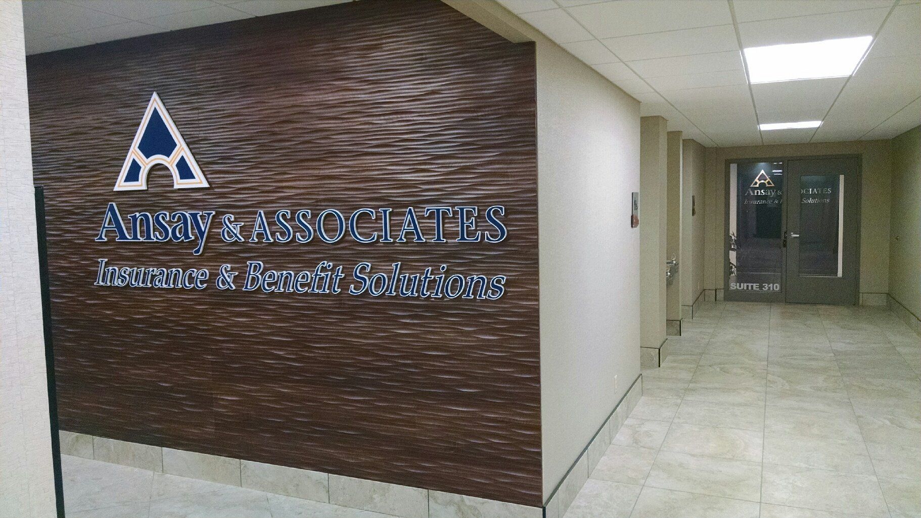 A hallway with a sign on the wall that says agency associates