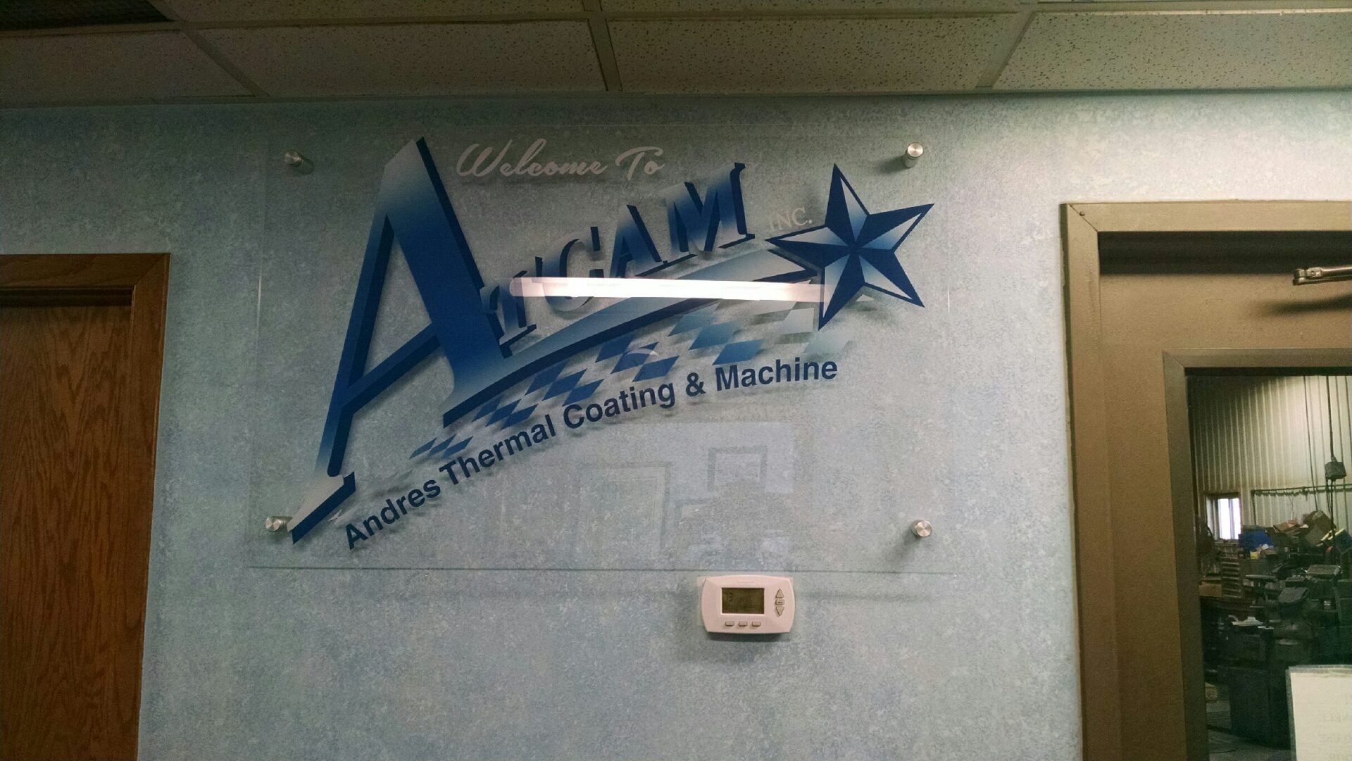 A sign on a wall that says always thermal coating a machine