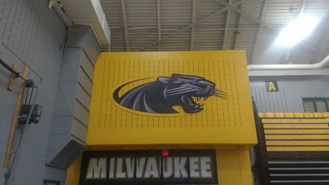 The milwaukee panthers logo is on a yellow sign