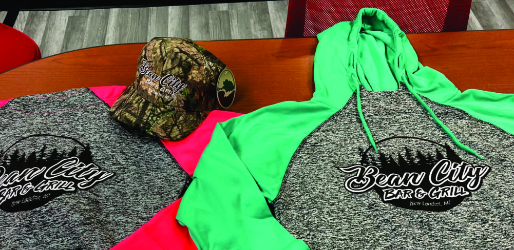 A hoodie and a hat are sitting on a table.