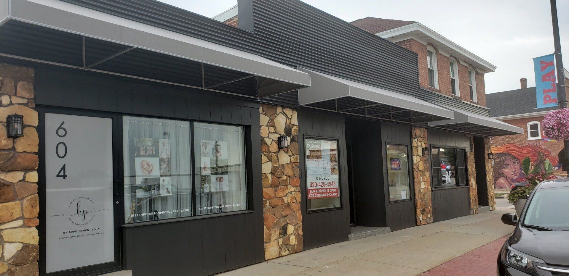 A car is parked in front of a building.