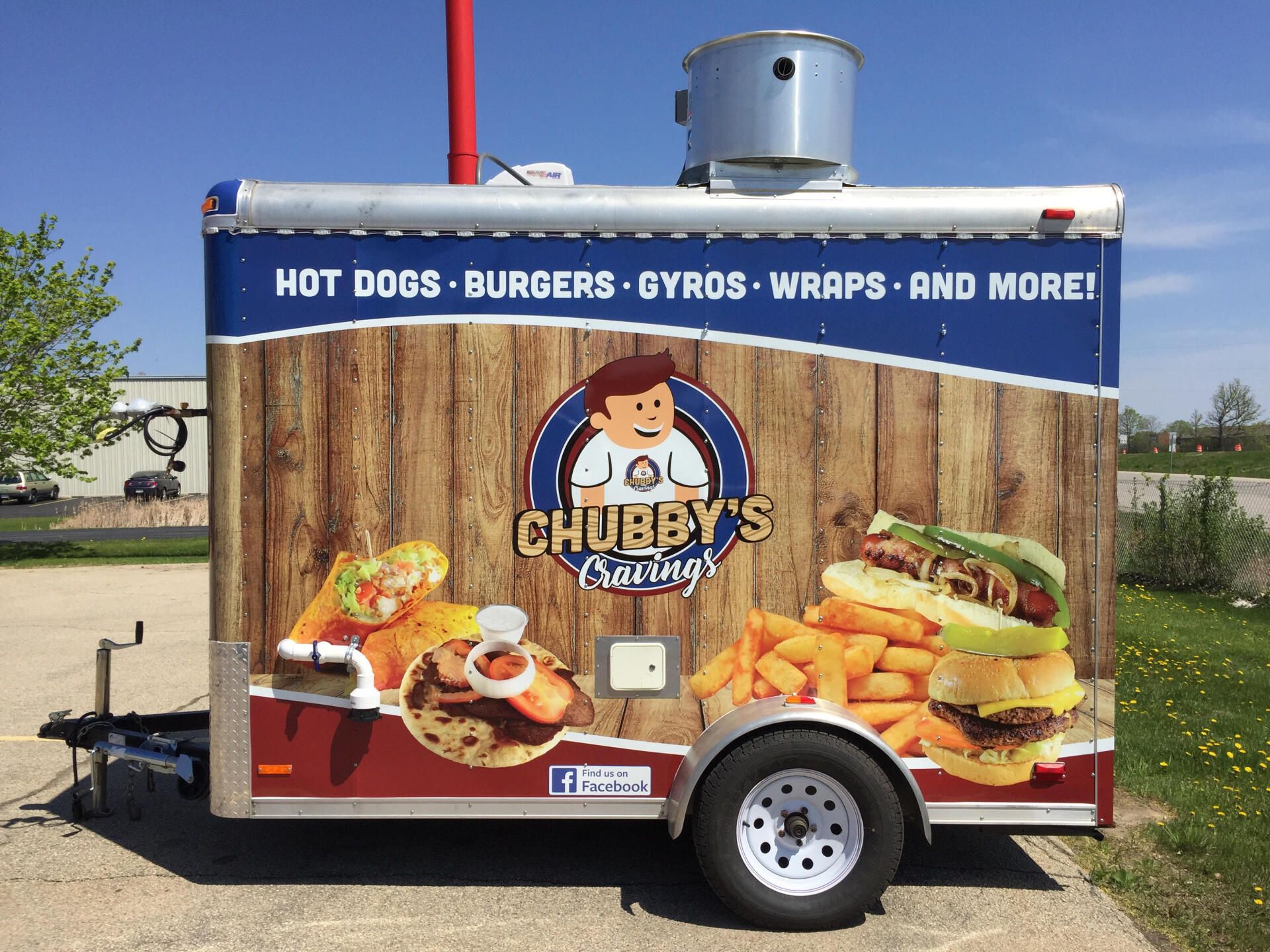 A trailer advertising chubby 's catering hot dogs burgers gyros wraps and more