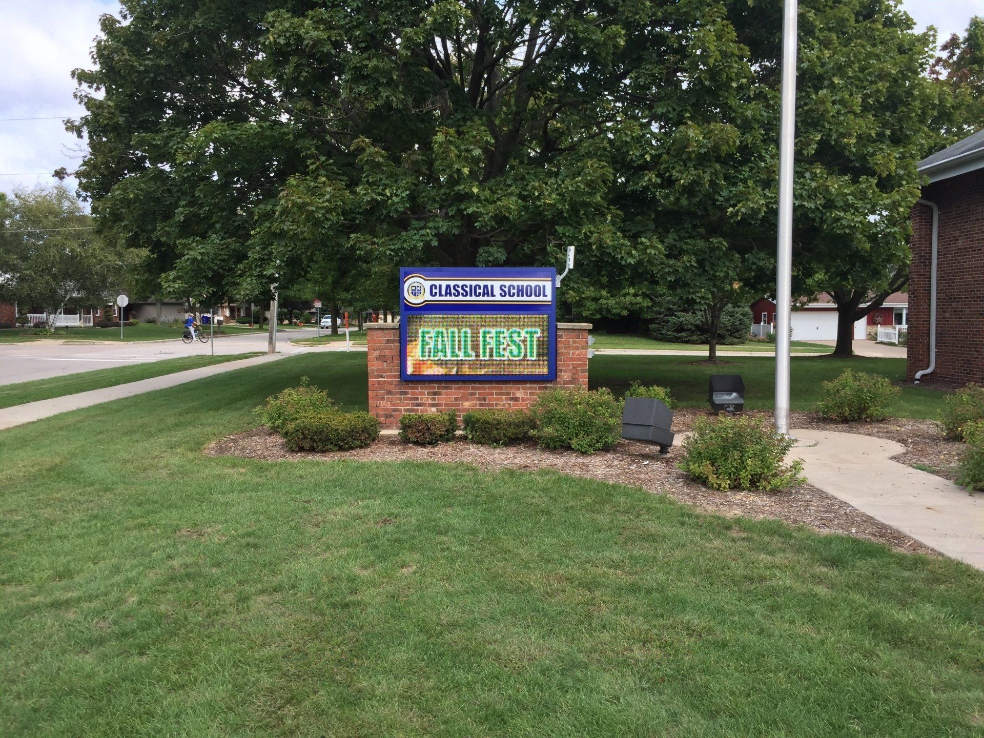 A sign that says cola fest is in front of a brick building.