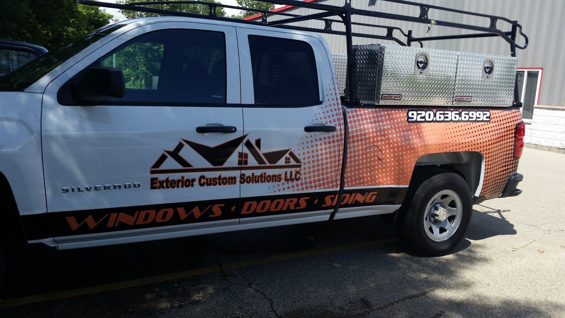 A white truck is parked on the side of the road.