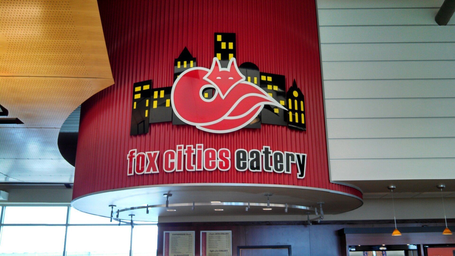 A sign for fox city eatery hangs from the ceiling