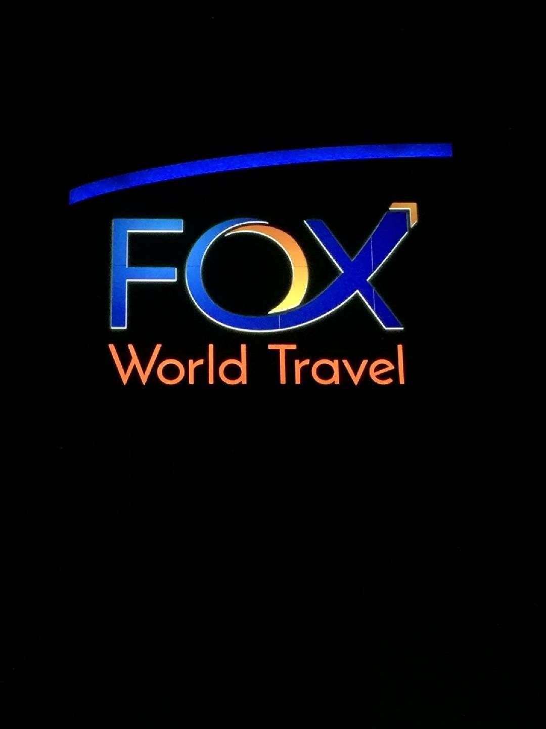 A fox world travel logo on a black background