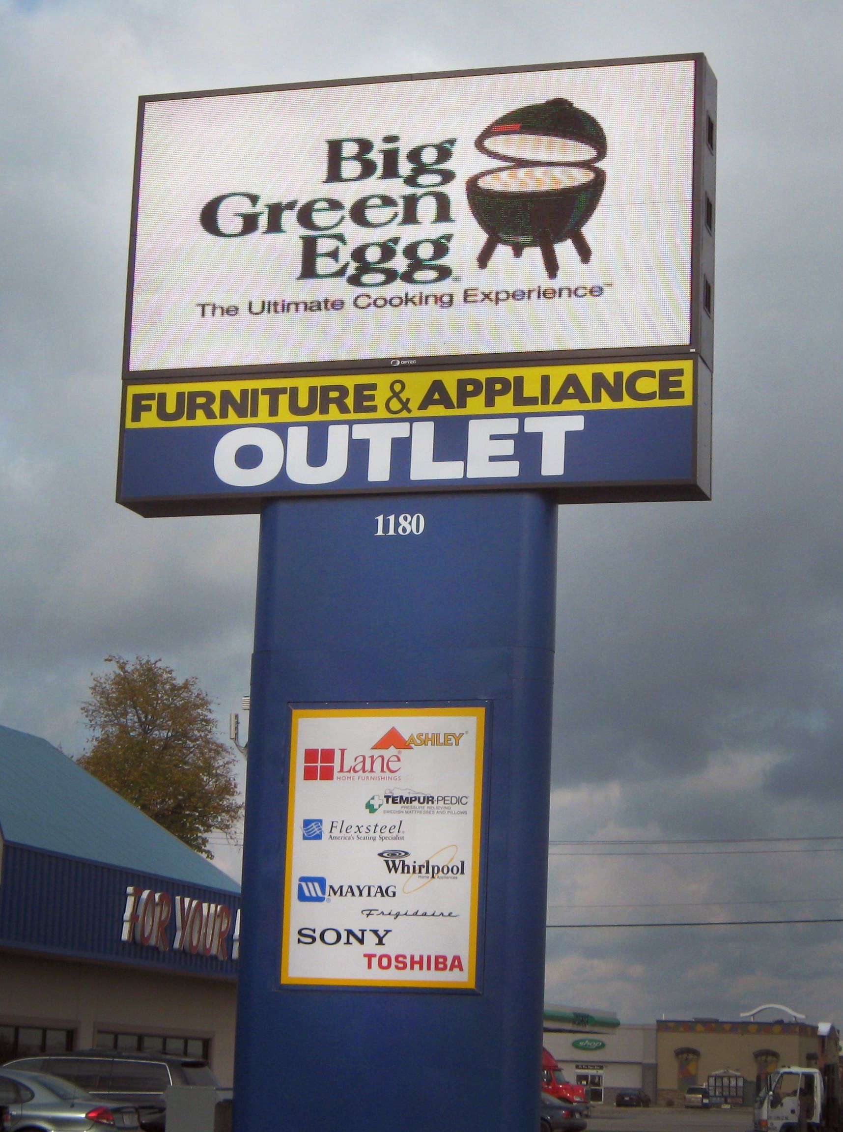 A big green egg furniture and appliance outlet sign