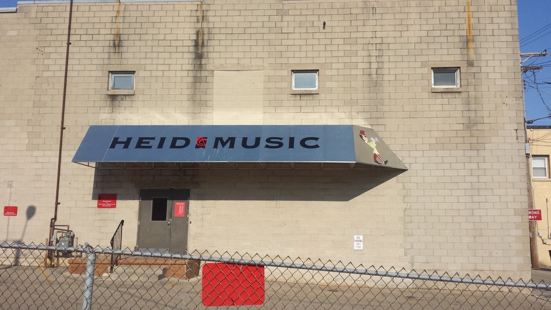 A building with a blue awning that says heid music