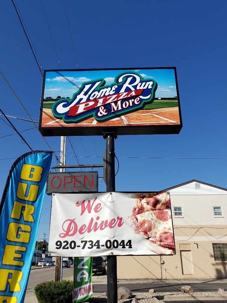 A sign for home run pizza and more is hanging on a pole.
