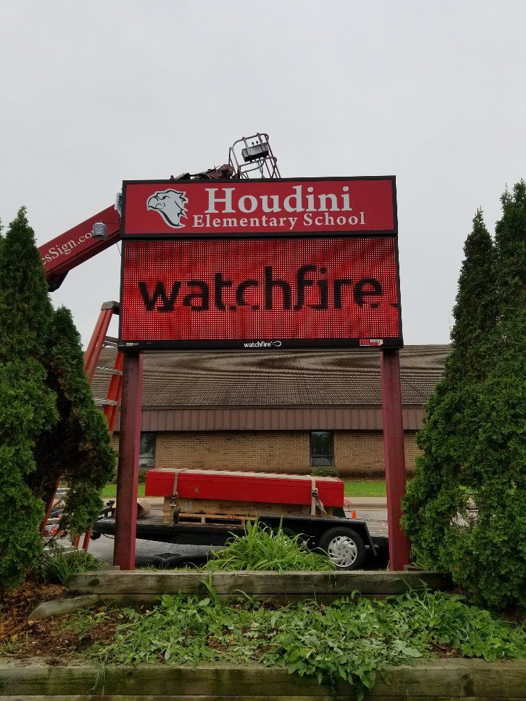 A sign for houdini elementary school is being installed