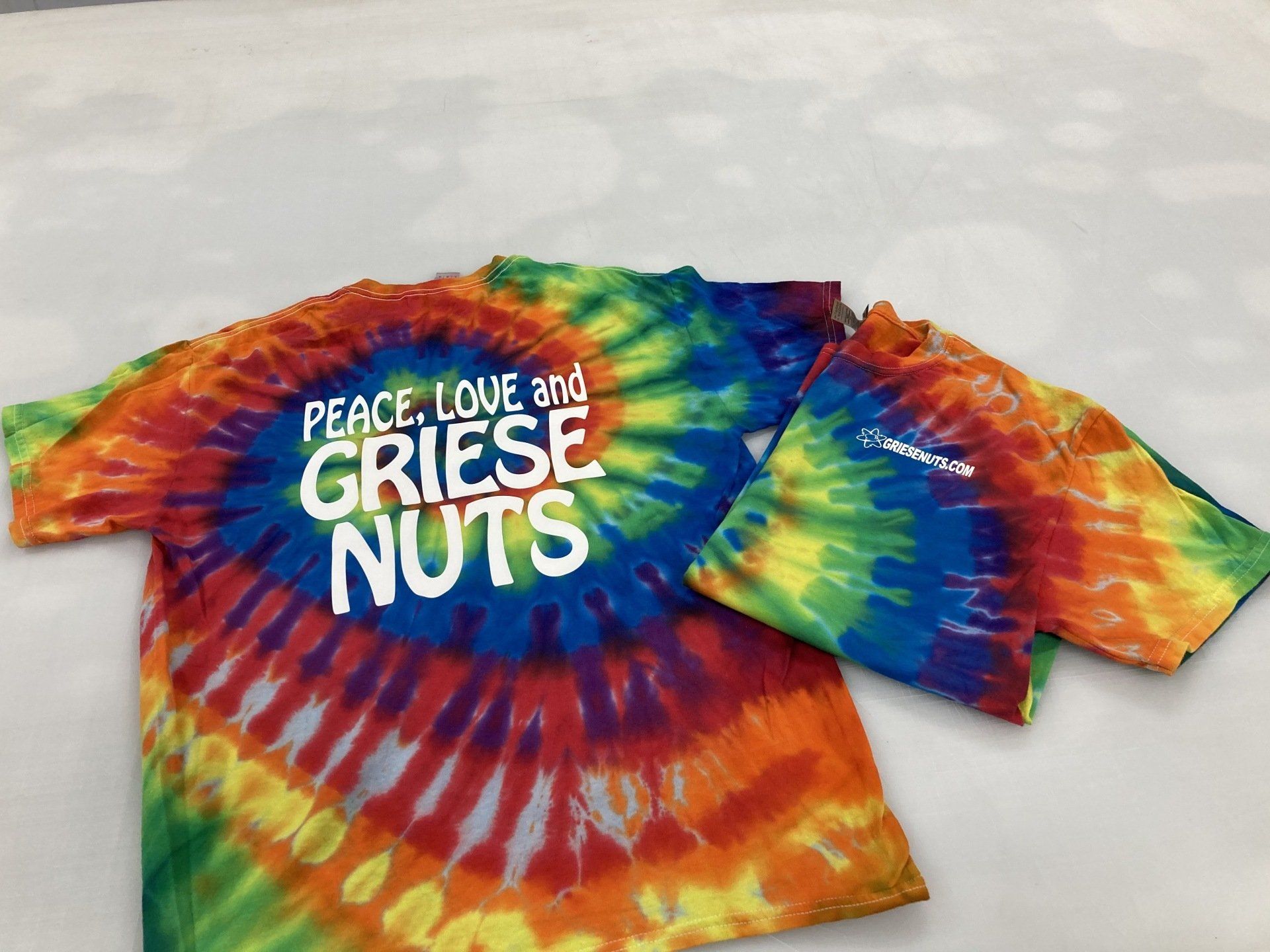 A tie dye t-shirt that says peace love and griese nuts