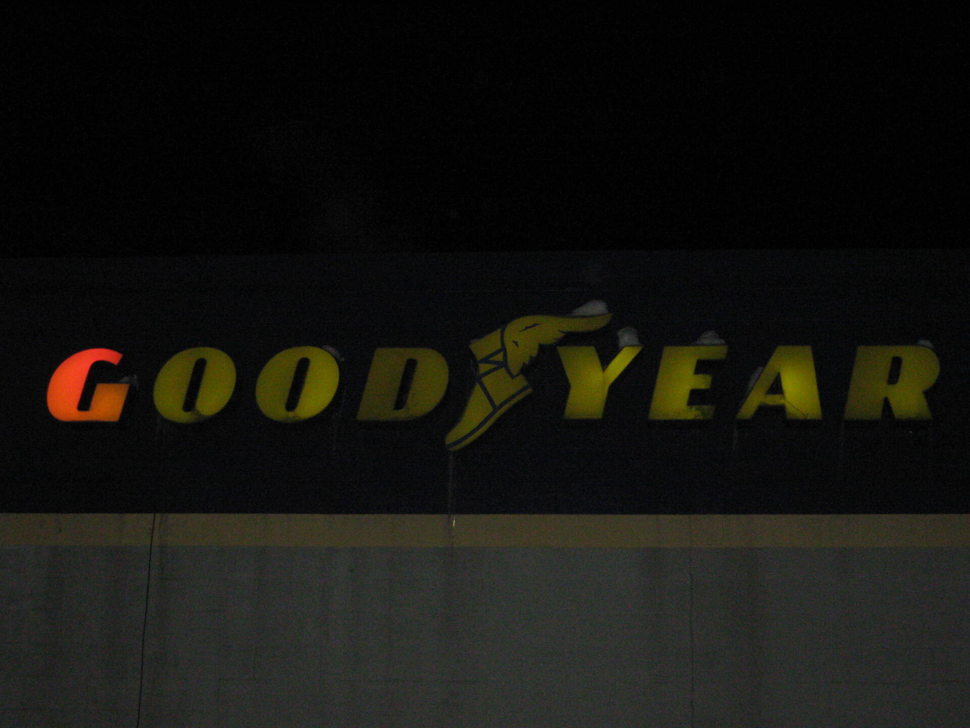 A good year sign is lit up in the dark