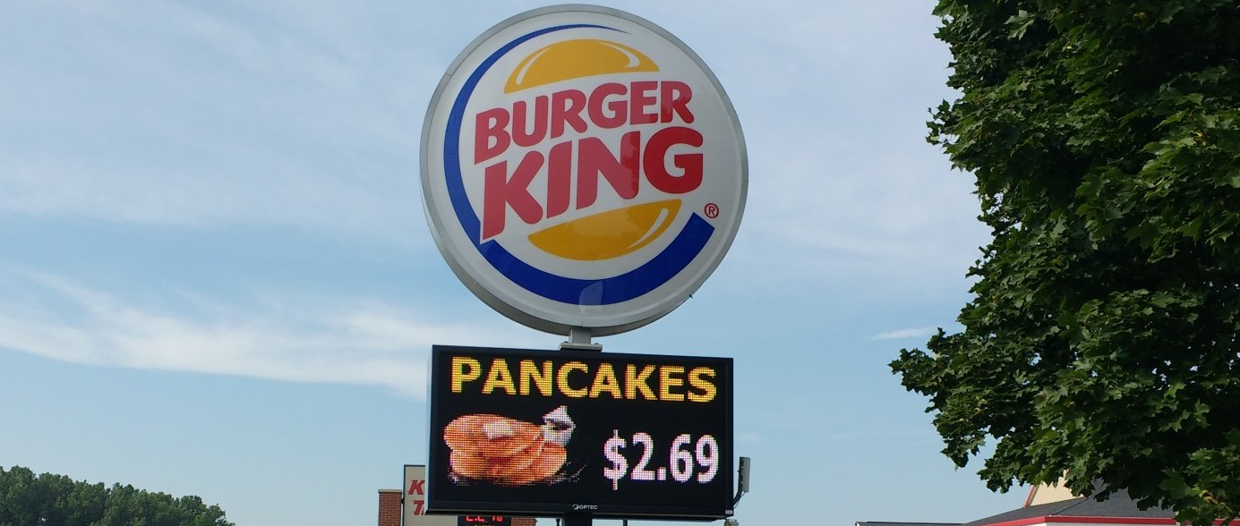 A burger king sign advertises pancakes for $ 2.69