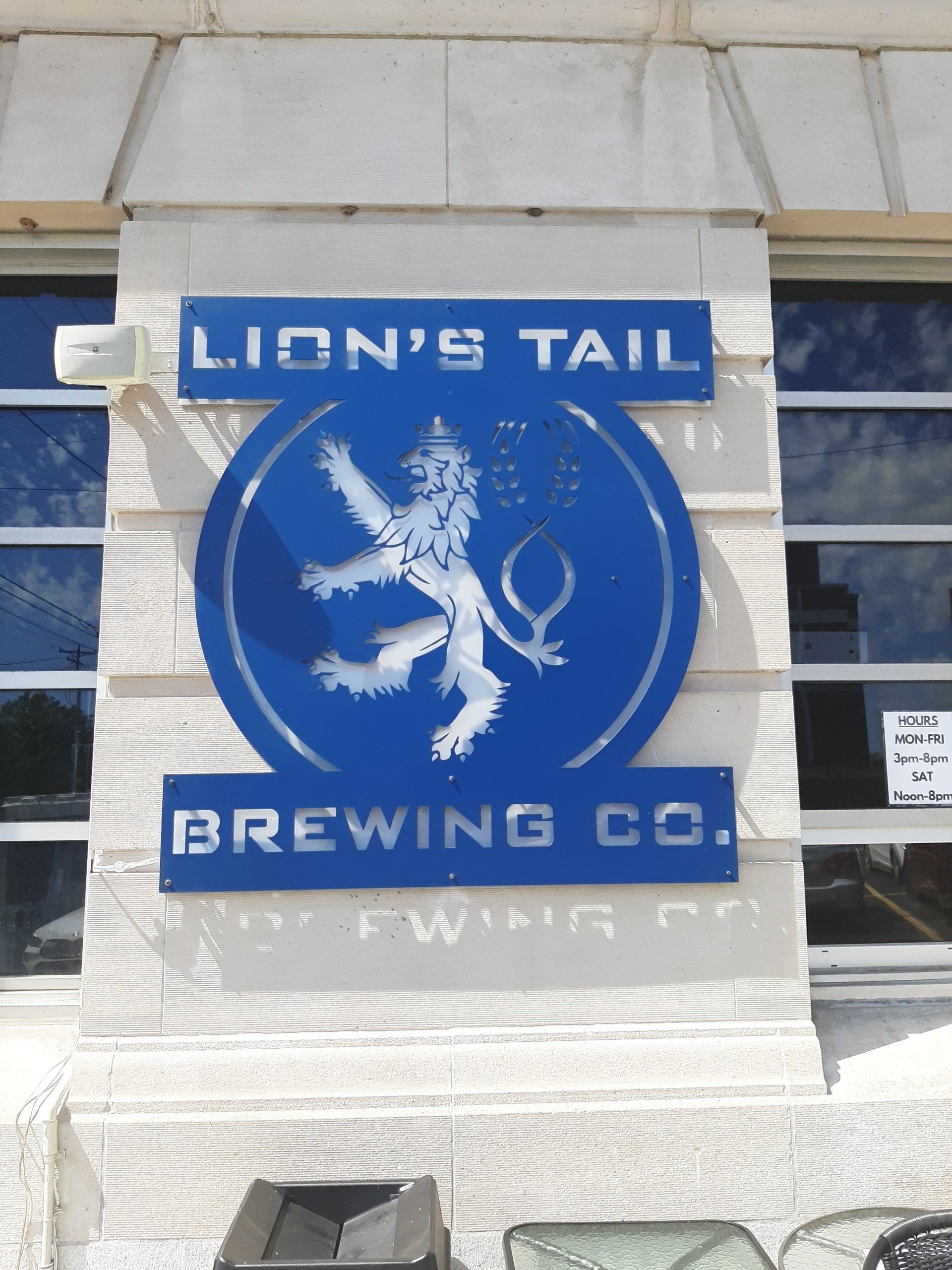 A sign for lion 's tail brewing co. with a lion on it