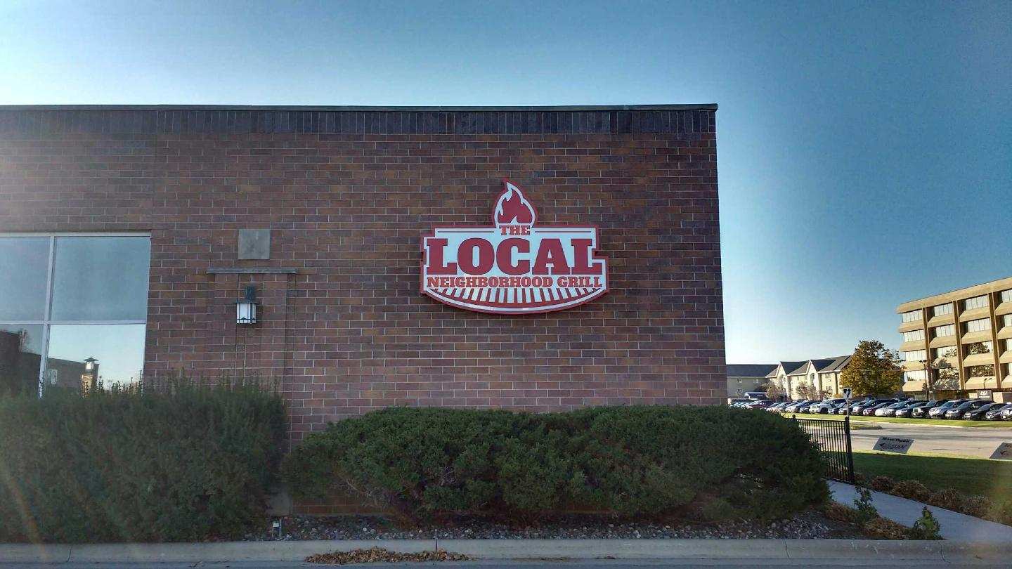 A brick building with a sign that says `` local '' on it.