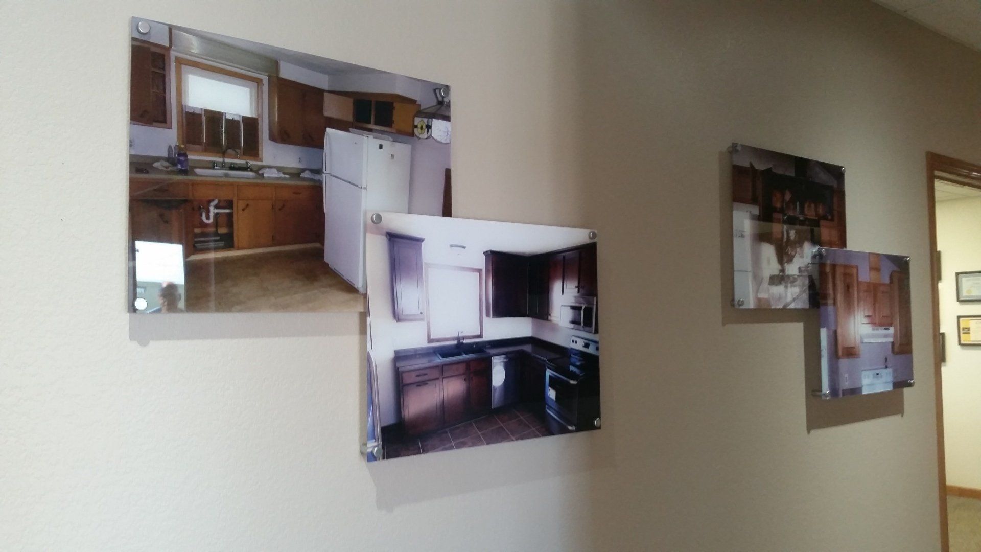 Three pictures of a kitchen are hanging on a wall