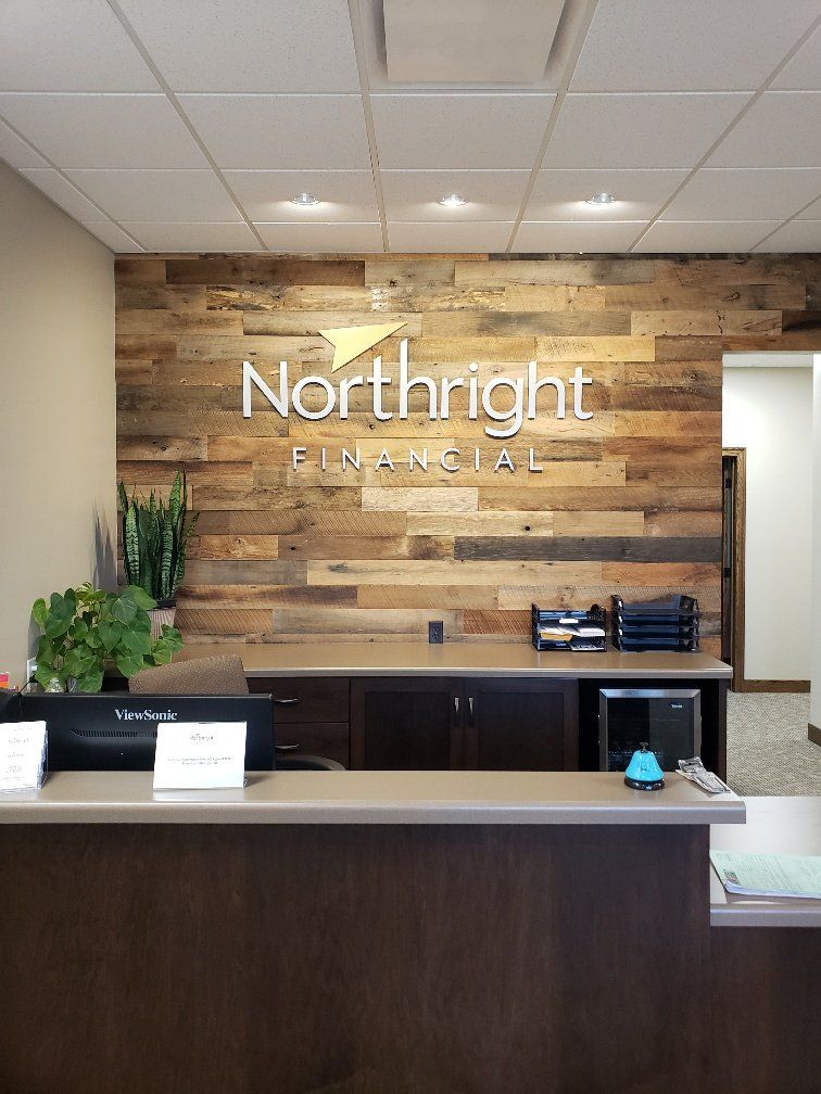 A reception area for northright financial with a wooden wall