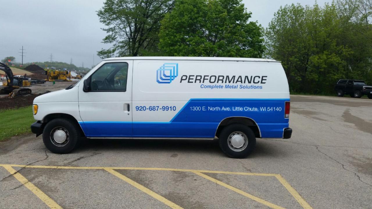 A performance van is parked in a parking lot