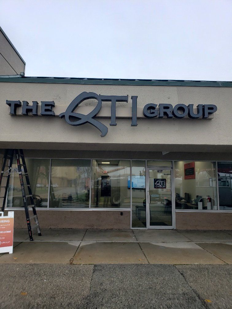 A building with a sign that says the qt group