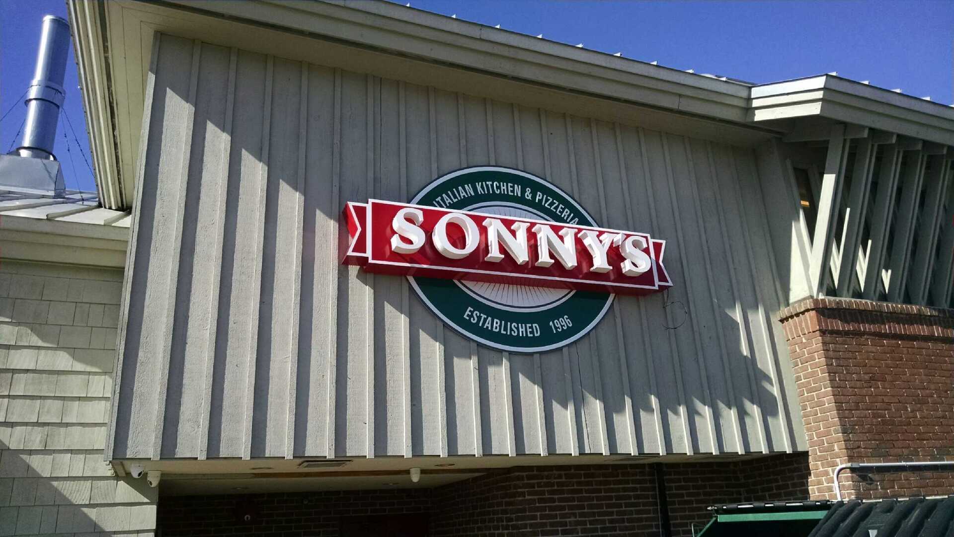 A sonny 's restaurant with a car parked in front of it