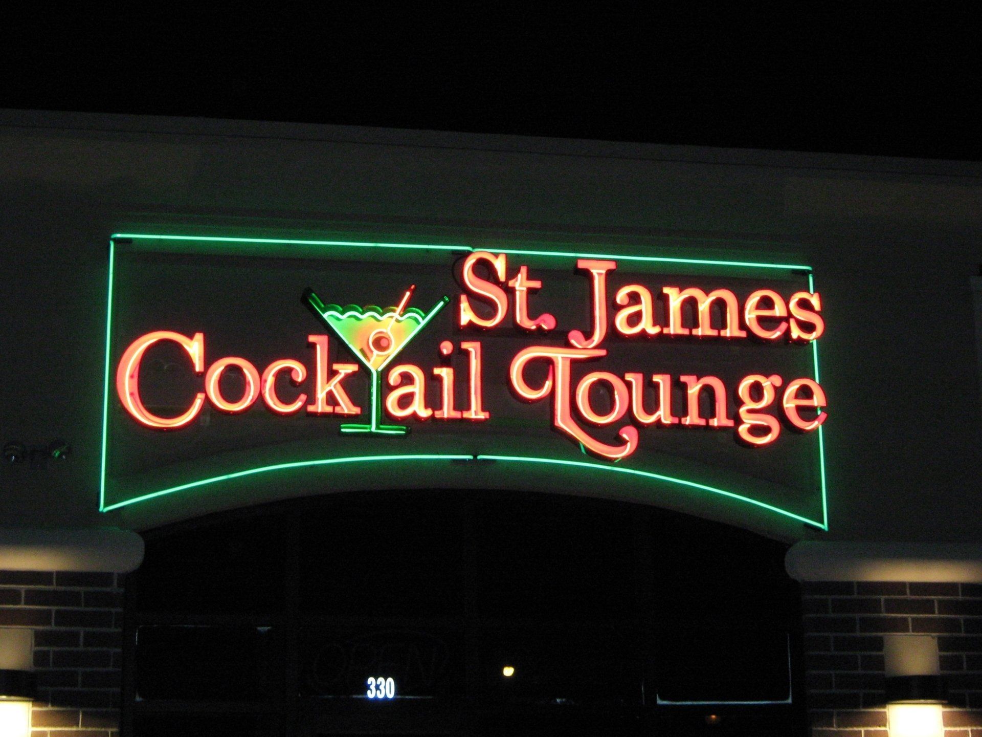 A neon sign for st. james cocktail lounge