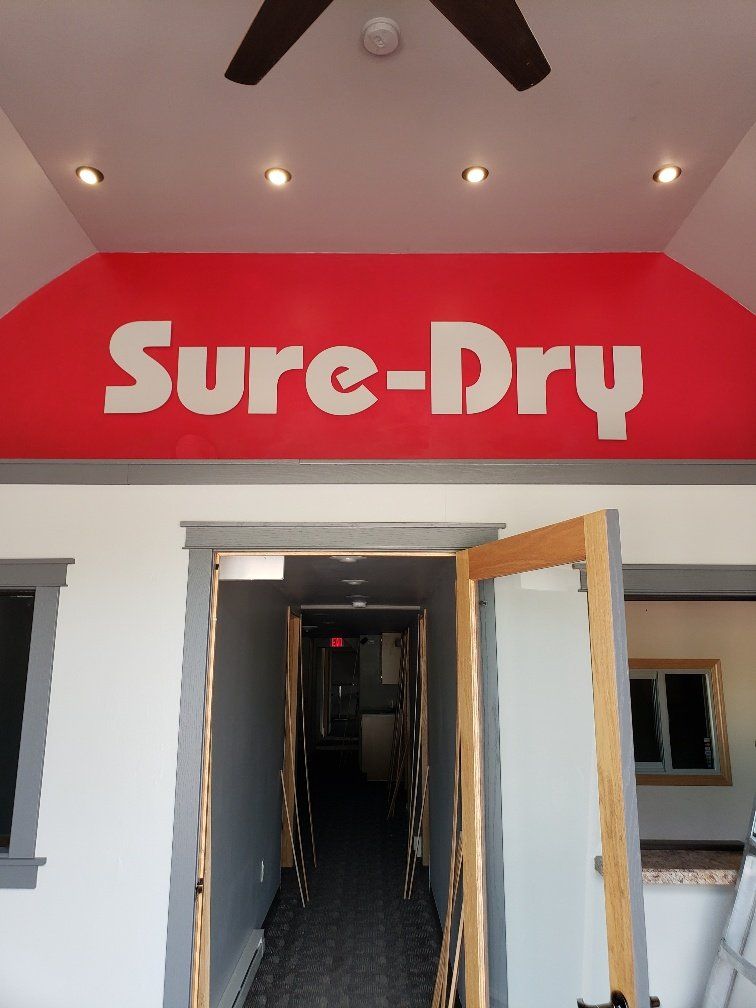 A building with a red sign that says sure-dry