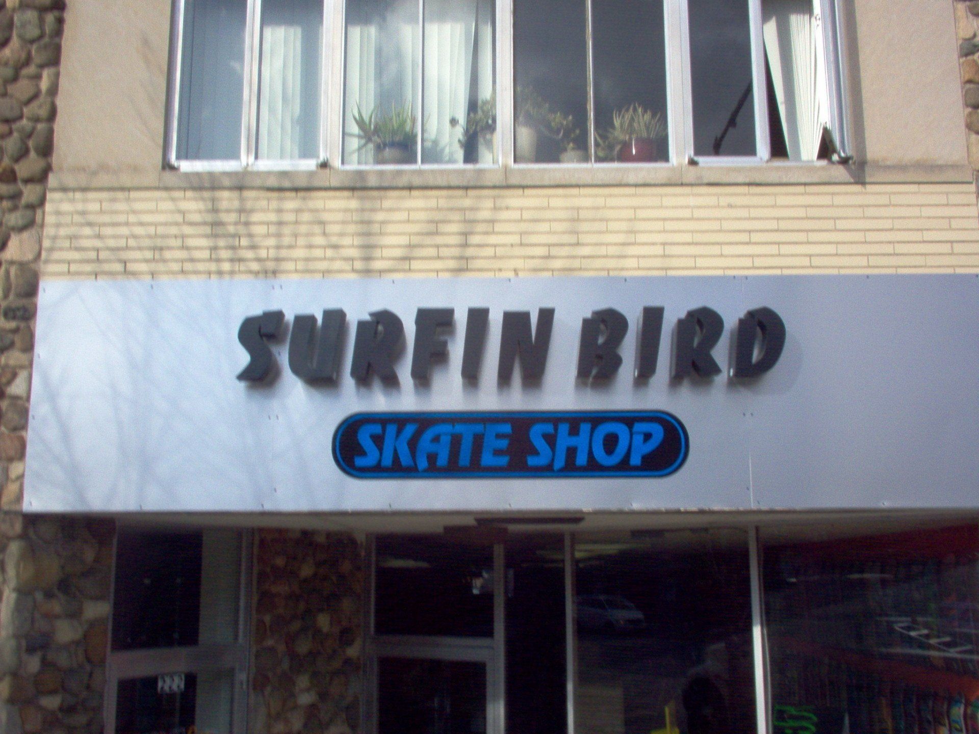 A building with a sign that says surfin bird skate shop