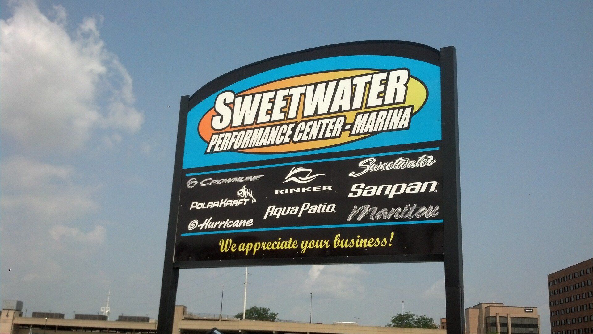 A sign for sweetwater performance center and marina