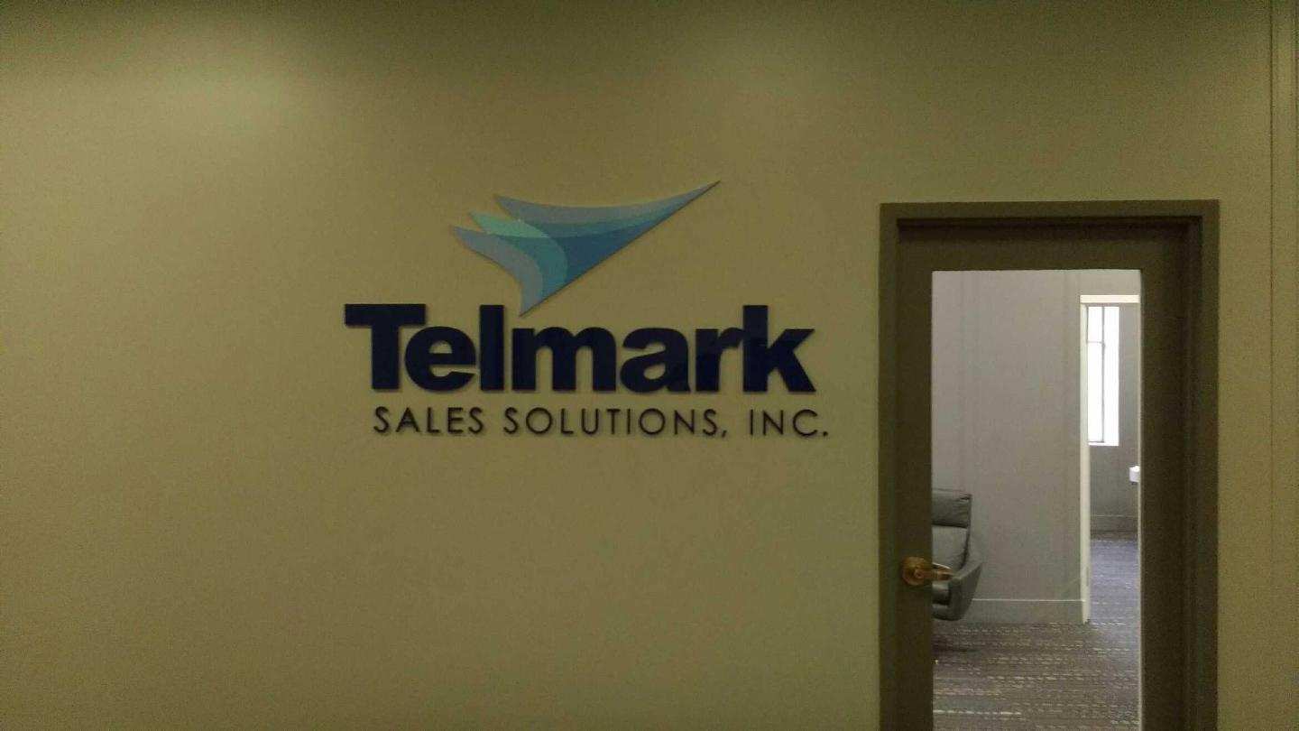 A sign on a wall that says telmark sales solutions inc.