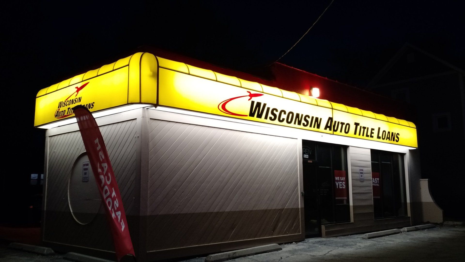 A wisconsin auto title loan store is lit up at night