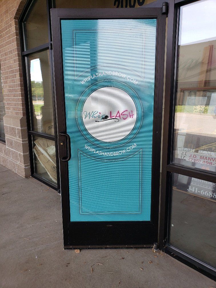 A blue door with a logo on it is open to a building.
