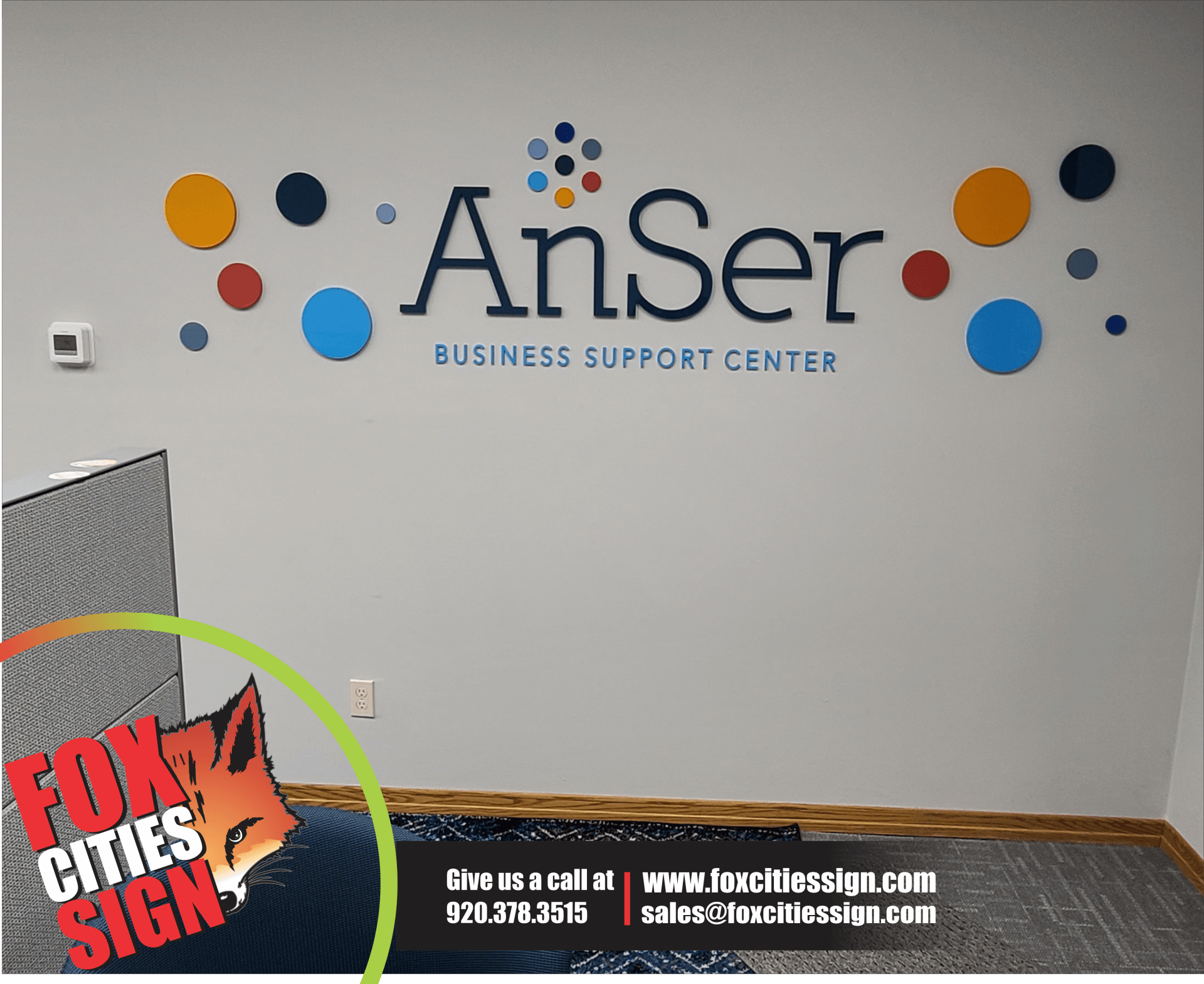 A wall with a sign that says anser business support center