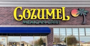 A brick building with a sign that says gozumel mexican grill