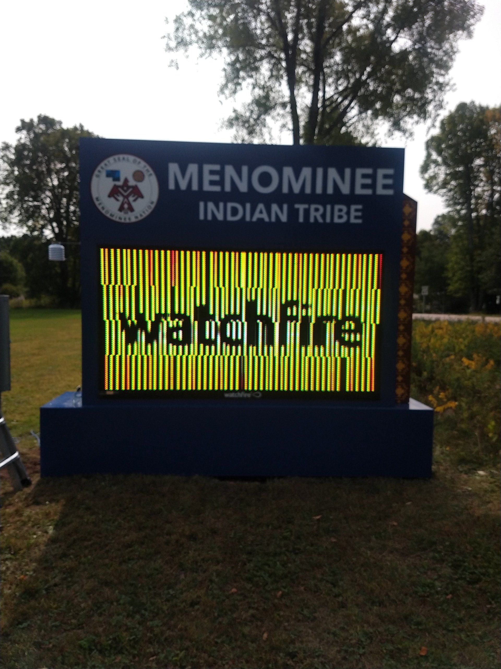 A sign that says menominee indian tribe on it