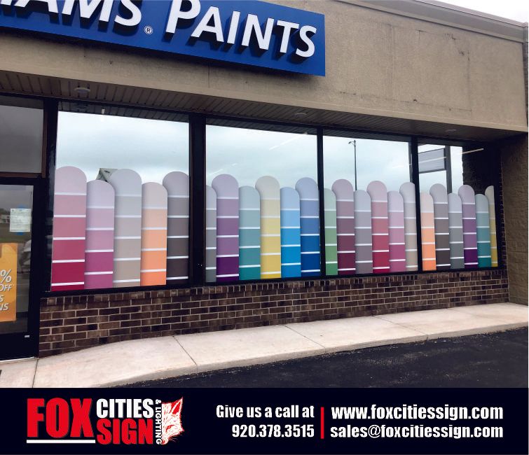 A display of paint samples in a store window