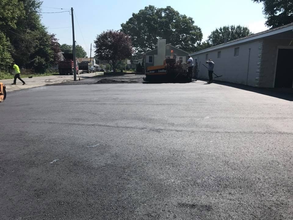 A group of people are working on a parking lot