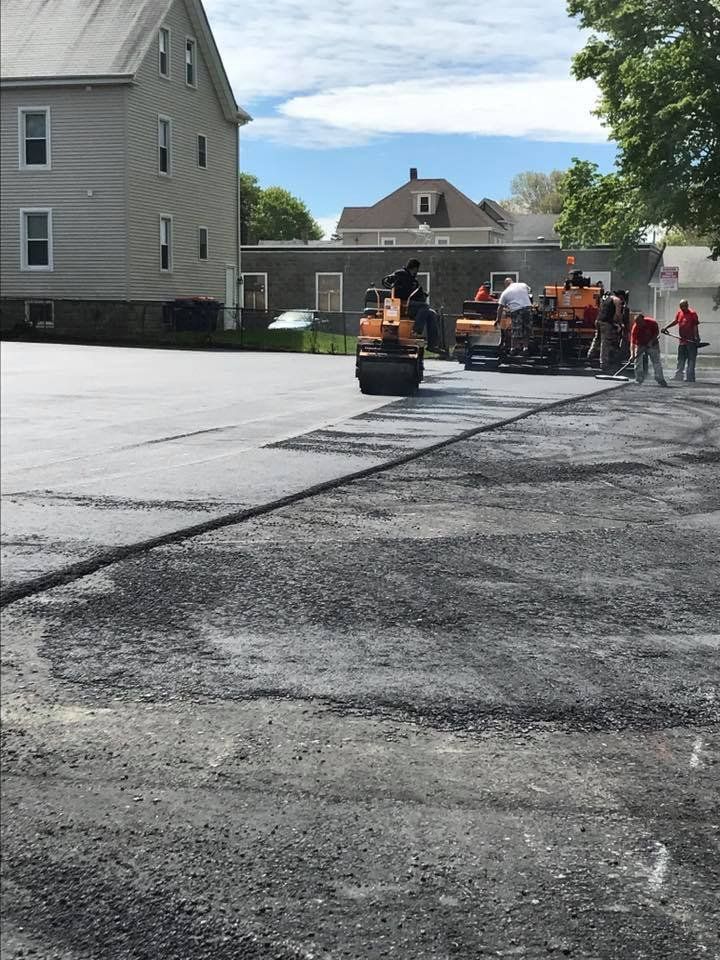 A group of construction workers are working on a road