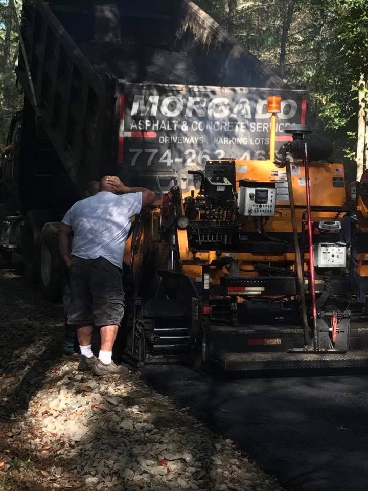 A man is standing in front of a truck with a sign on it.